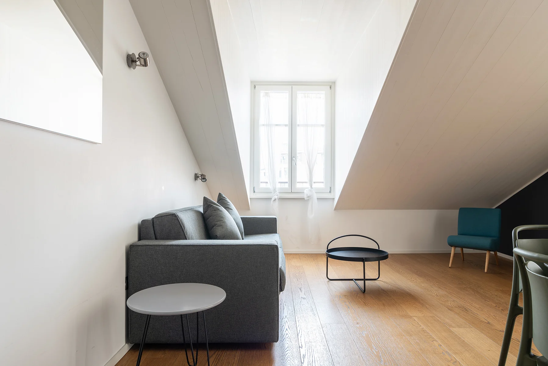 Soggiorno luminoso Brera Luxury Suites con divano blu e parete navy